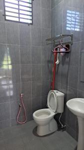 a bathroom with a toilet and a sink at Aja Retreat Bungalow OnlyMuslim in Jitra