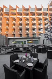 a table and chairs in front of a building at Long Beach Hotel in Cox's Bazar