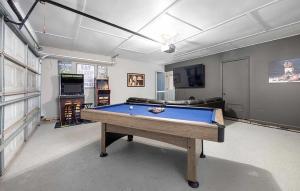 a living room with a pool table in it at Ultimate Getaway with Pool and Games in Columbus