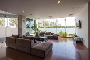 a large living room with couches and a large window at Long Beach Hotel in Cox's Bazar