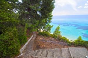 a stairway leading up a hill to the ocean at Elia Apartments Sithonia in Elia