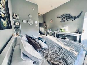 a bedroom with a large bed and a desk at Gladstudio in Kerobokan