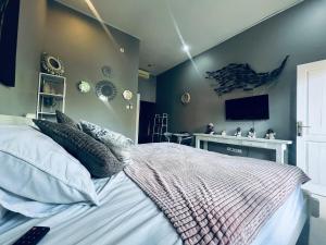 a bedroom with a bed and a tv on the wall at Gladstudio in Kerobokan