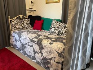 a bedroom with a bed with a floral comforter at Milbanksea in Portland