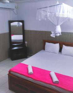 Postel nebo postele na pokoji v ubytování New Araliya Resort