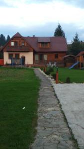 a house with a stone path in front of it at Chalupa ŠŠ in Vlachy