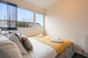 a bedroom with a bed and a large window at Large spacious and spotless house with hot tub and snooker and table tennis NEC,JLR,Airport Sleeps 8 in Water Orton