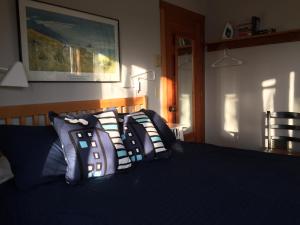 a room with a bed, a desk, and some pillows at Harrison Street Inn in Cannon Beach