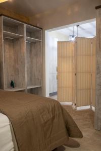 a bedroom with a bed and a sliding glass door at Valletta City Suites in Valletta +55 photos