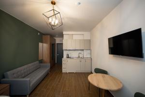 a living room with a couch and a table at Gоderdzi Twins Hotel in Goderdzi