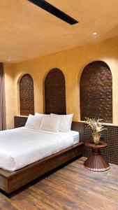 a bedroom with a large white bed with two arches at Palazzo Luxury Villa 950m2, 7 bedrooms, Pickleball court, swimming pool in Ha Long