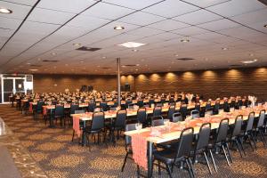 a large banquet hall with tables and chairs at Historic Cow Palace Inn in Lamar