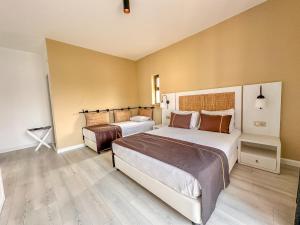 A bed or beds in a room at Ayvalık Sea Resort