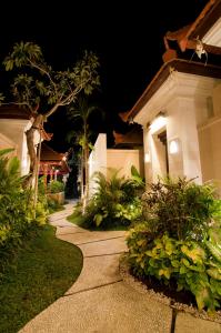 a walkway in front of a house at night at Villa Puspa in Tanah Lot