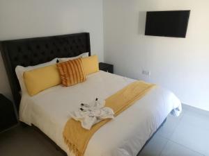 a bedroom with a bed with towels on it at Accomodation 5050 Jwaneng in Jwaneng