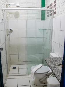 a bathroom with a shower with a toilet and a sink at Pousada Vila do Mar in São Luís