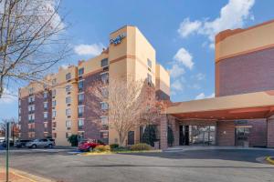 a hotel building with a parking lot in front of it at Comfort Inn University Center in Fairfax