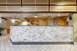 a lobby with a stone wall in a building at Comfort Inn University Center in Fairfax