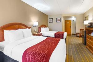 a hotel room with two beds and a television at Comfort Inn University Center in Fairfax