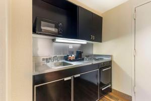 a kitchen with a sink and a microwave at Comfort Inn University Center in Fairfax