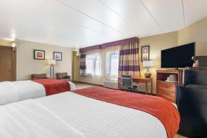 a hotel room with two beds and a flat screen tv at Comfort Inn University Center in Fairfax