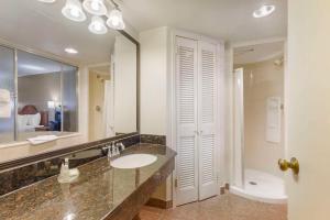 a bathroom with a sink and a mirror and a toilet at Comfort Inn University Center in Fairfax