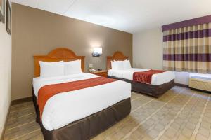 a hotel room with two beds and a window at Comfort Inn University Center in Fairfax