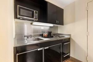 a kitchen with a sink and a microwave at Comfort Inn University Center in Fairfax