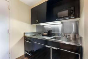 a kitchen with a sink and a microwave at Comfort Inn University Center in Fairfax