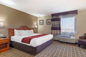 a hotel room with a bed and a window at Comfort Inn University Center in Fairfax