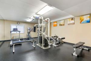a gym with treadmills and machines in a room at Comfort Inn University Center in Fairfax
