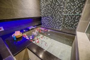 bagno con doccia con fiori in acqua di SIX FUKUN HOTEL a Jiaoxi