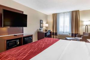 a hotel room with a bed and a flat screen tv at Comfort Inn Great Falls South in Great Falls +25 photos