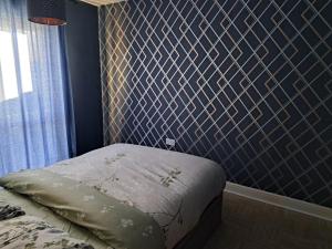 a bedroom with a bed and a blue wall at Delightful double room in home in Nottingham