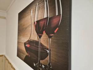 a picture of two glasses of wine on a wall at Apartament Verde Residence Slănic-Moldova in Slănic-Moldova