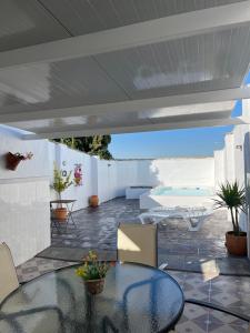 a patio with a table and chairs and a pool at La Casilla in Montilla