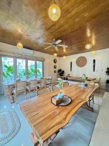 a dining room with a wooden table and chairs at Lavella Villas Kuta Lombok in Kuta Lombok