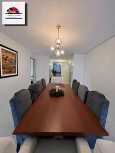 a conference room with a large wooden table and chairs at Lakeview Penthouse by Timothy in Tagaytay