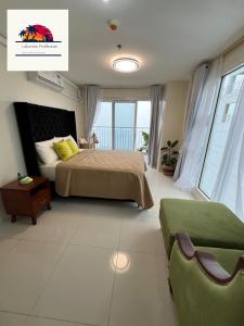 a bedroom with a bed and a view of the ocean at Lakeview Penthouse by Timothy in Tagaytay