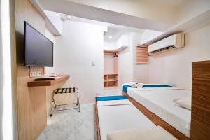 Televiisor ja/või meelelahutuskeskus majutusasutuses Circuit Hostel