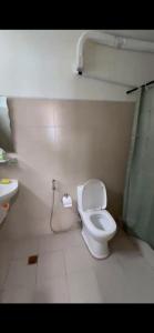 a bathroom with a toilet and a sink at Lakeview Penthouse by Timothy in Tagaytay +19 photos