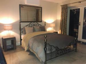 a bedroom with a large bed with a large mirror at Beautiful garden room in Red Lodge