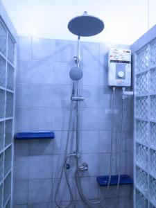 a shower in a bathroom with a shower head at Jaydahouse hatyai in Sathani Hat Yai +37 photos