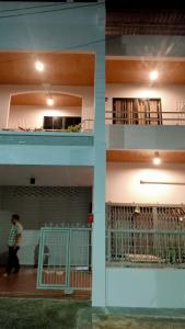 a person walking in front of a building at Jaydahouse hatyai in Sathani Hat Yai