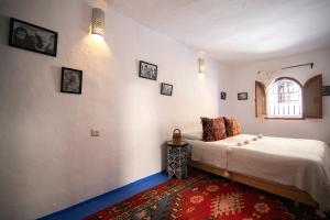 a bedroom with a large bed and a window at Casa Raselma - Rela Mountains & Spectacular Views in Chefchaouen