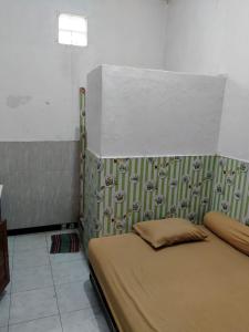 Postel nebo postele na pokoji v ubytování Griya kost