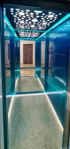 an empty room with blue lights on the ceiling at The ideal place by the sea Mamaia Nord Lidl area in Mamaia Nord