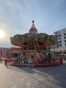 a carousel in a parking lot in a city at The ideal place by the sea Mamaia Nord Lidl area in Mamaia Nord +24 photos