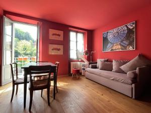 a red living room with a couch and a table at Oriental Coast Varenna in Perledo +25 photos