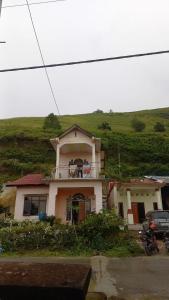a house on top of a hill with at Toba Breeze in Pangururan +8 photos